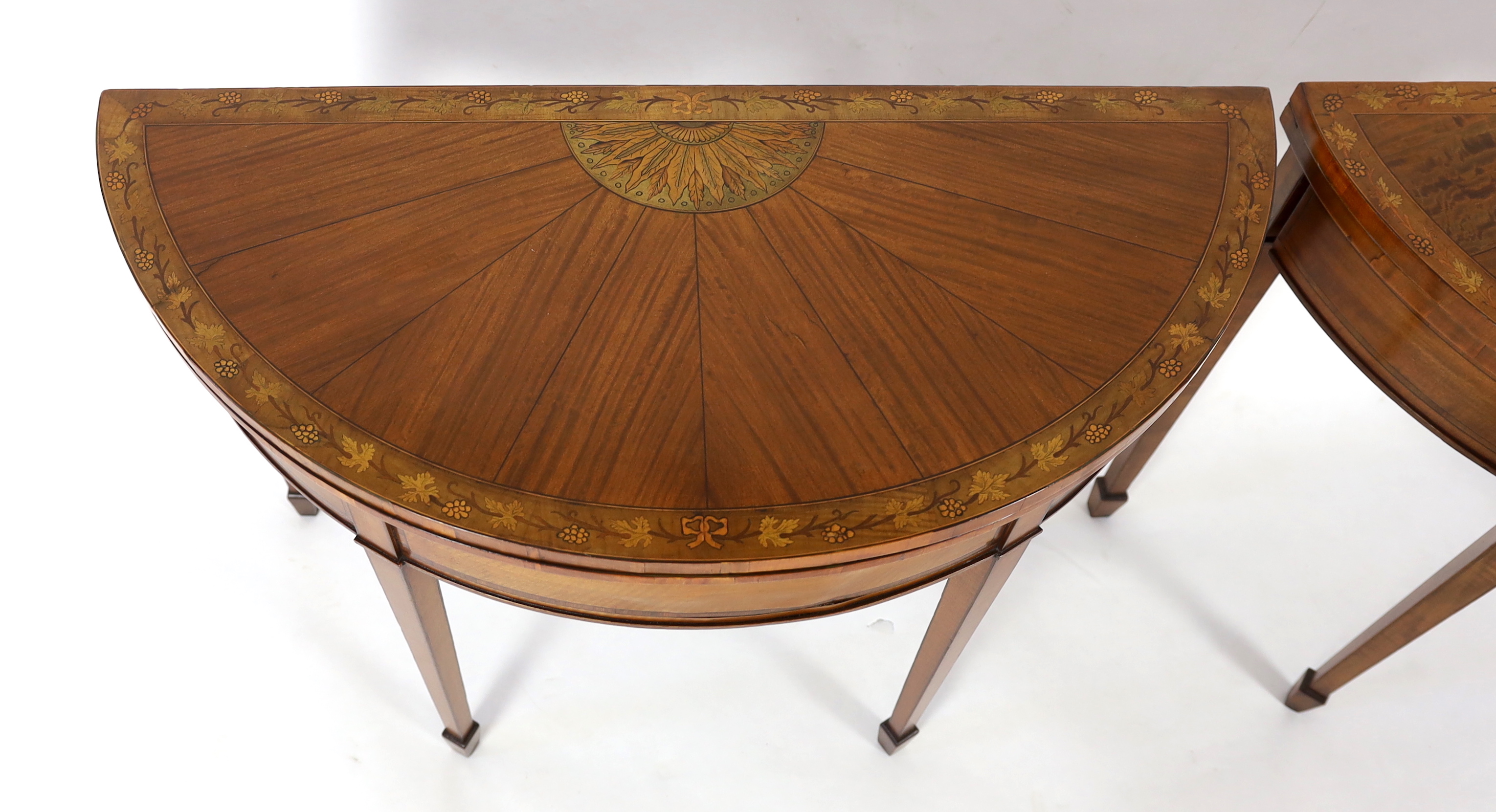 A pair of Edwardian Sheraton revival marquetry inlaid satinwood card tables